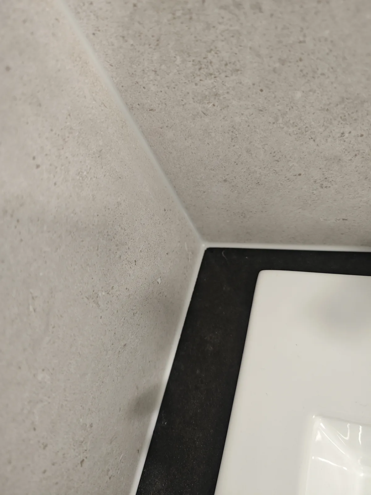 Close-up of a sealed stone benchtop and basin junction, Melbourne caulking